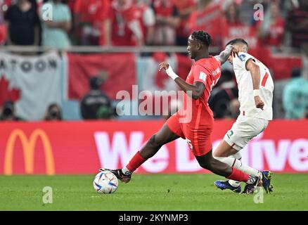 Doha, Qatar. 1st Dec, 2022. Ismael Kone of Canada and Hakim Ziyech of Morocco in action during their Group F match at the 2022 FIFA World Cup at Al Thumama Stadium in Doha, Qatar, Dec. 1, 2022. Credit: Xin Yuewei/Xinhua/Alamy Live News Stock Photo