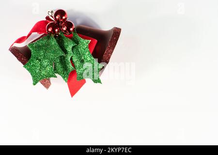 Merry Christmas greeting card background, white background, room for text, red bell and evergreen ornament Stock Photo