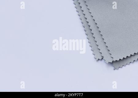 Grey micro fibre cloth. Microfiber cleaning cloth for glasses, eyeglass or camera lens on white background. Stock Photo