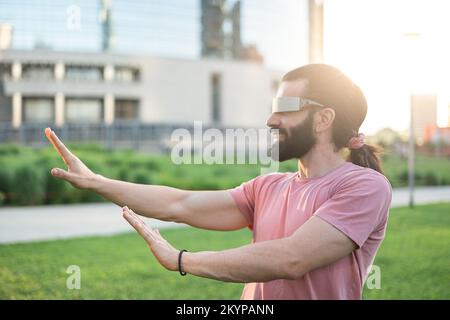 Young hispanic man wearing vr glasses Stock Photo