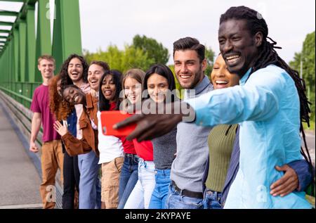Cheerful international happy friends taking selfies during travel in Spain Stock Photo