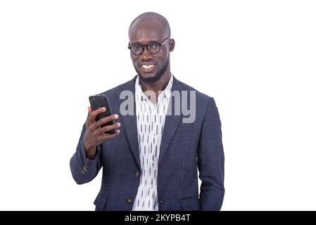 portrait of an adult businessman wearing glasses using a mobile phone while smiling. Stock Photo