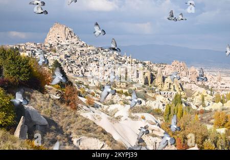 View of Uçhisar castle and cave city carved into the fairy chimneys in Cappadocia, Turkey, taken from Pigeon Valley on a bright cloudy Autumn day. Stock Photo