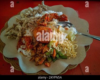 Mixed rice. A popular Indonesian specialty rice meal with various side dishes served with rice and others as optional additions. Stock Photo