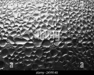 Glass with raindrops on dark tone background. Abstract wet texture with bubbles on window glass surface. Raindrop, Realistic pure water droplets conde Stock Photo