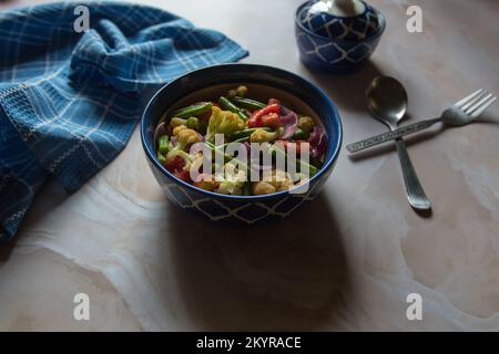 View from top of mixed vegetables curry served in a bowl. Stock Photo