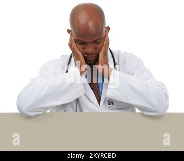 Overworked and tired. A young doctor leaning on copyspace and looking tired. Stock Photo