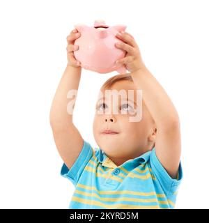 Good saving habits. Studio shot of a young boy holding up a piggy bank isolated on white.