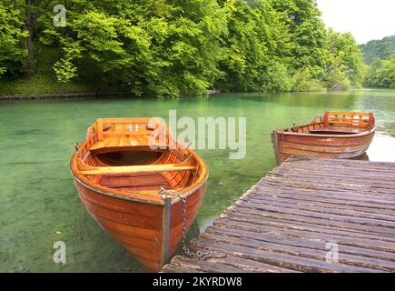Two wooden boats moored on a lake jetty