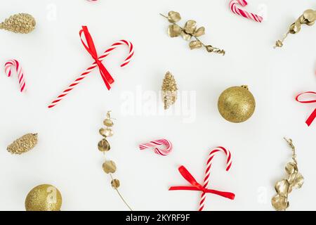Christmas pattern with tree decoration and candy canes on white. Flat lay, top view. New Year. Stock Photo