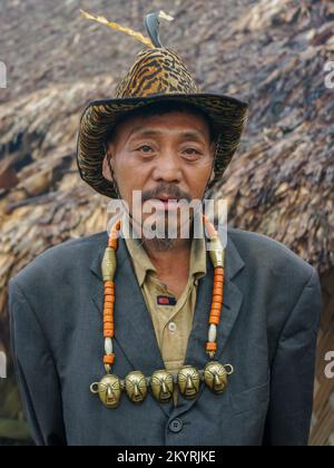 Longwa, Mon, Nagaland, India - 03 02 2009 : Portrait of the Chief Angh of the Naga Konyak Tribe wearing traditional headhunter necklace and hat Stock Photo