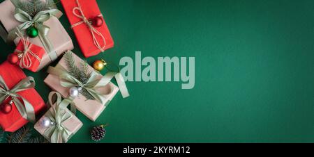 Banner with Christmas gift and decorations on green background. Stock Photo