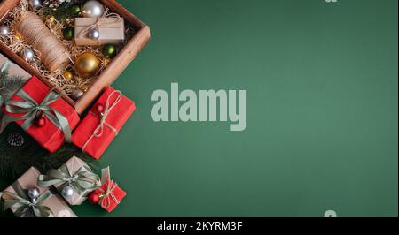 New Year banner with Christmas gift boxes and decorations on khaki background. Stock Photo
