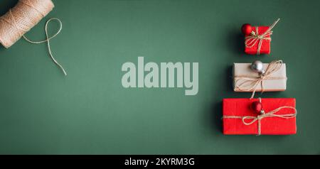 New Year banner with Christmas gift boxes and decorations on khaki background. Stock Photo