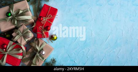 Christmas banner with many gift boxes with paper decorations on blue plaster background. Christmas background. Stock Photo