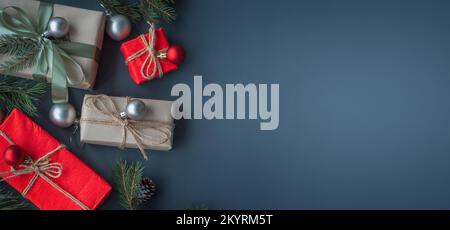 New Year banner with Christmas gift boxes and decorations on grey background. Stock Photo