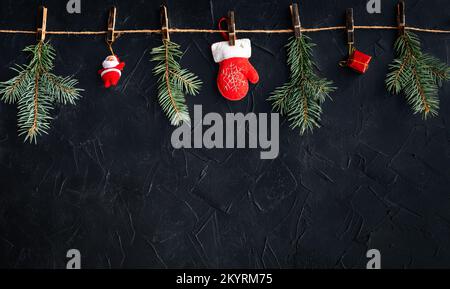 Christmas banner with many gift boxes with paper decorations on black plaster background. Christmas background. Stock Photo