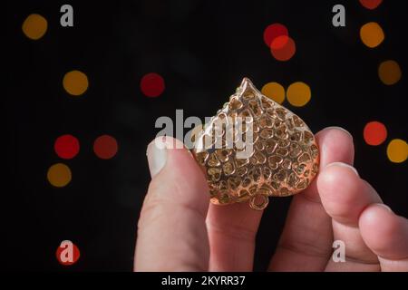 Heart shape icon in hand on bokeh light Stock Photo