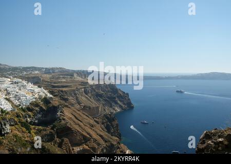 Santorini, Greece - September 16, 2022 : Panoramic view of a ferry boat arriving at the picturesque island of Santorini Greece Stock Photo