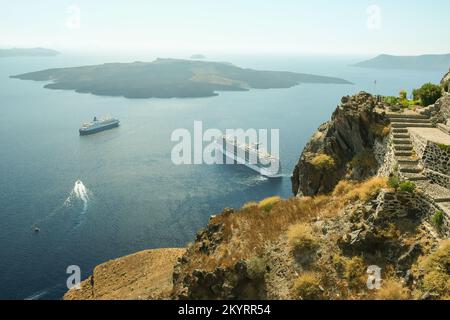 Santorini, Greece - September 16, 2022 : Panoramic view of two cruise ships next to the volcano and a beautiful blue sky in Santorini Greece Stock Photo