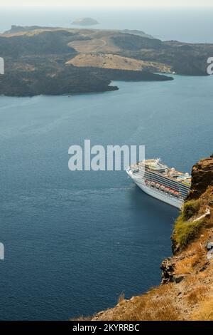 Santorini, Greece - September 16, 2022 : View of a cruise liner next to the famous volcano of Santorini Stock Photo