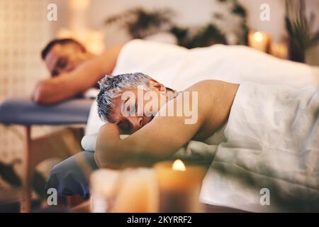 Woman, spa and couple massage for relax, peace and skincare wellness at holiday resort. Calm, mature and sleeping lady on luxury salon bed with Stock Photo