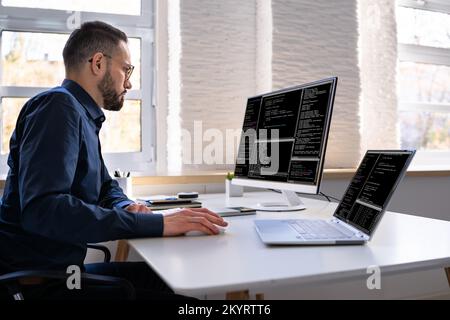 Software Programmer Or Coder Man Using Office Computer Stock Photo