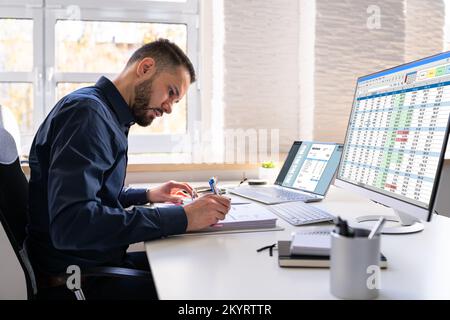 Analyst Working With Spreadsheet On Computer Screen Stock Photo