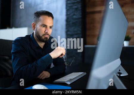 Late Night Workaholic Busy Business Man At Computer Stock Photo