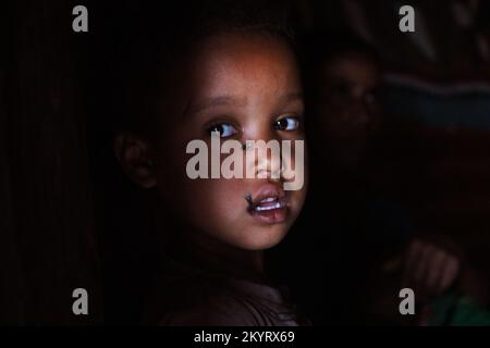 Child inside his hut, Ethiopia Stock Photo