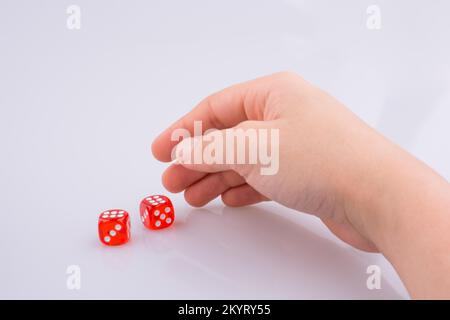 Hand holding red dice on a white background Stock Photo