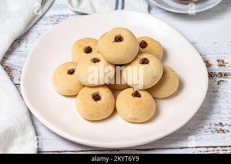 Pistachio cookies. Cookies with flour on wood background. close up Stock Photo
