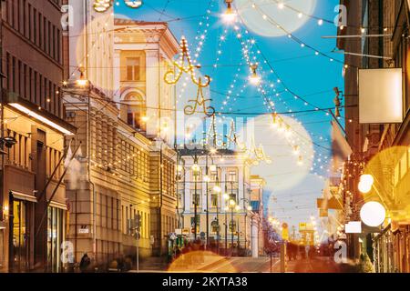 Helsinki, Finland. Light Blue Dramatic Sky. Night Evening Christmas Xmas New Year Festive Boke Illumination On Aleksanterinkatu Street. Beautiful Stock Photo