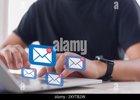 Man checking email icon online or sending mail to partner and customer on web with virtual interface technology concept. Stock Photo