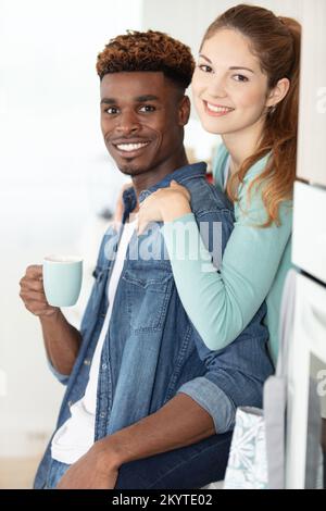 young couple drinking coffee in a modern kitchen Stock Photo