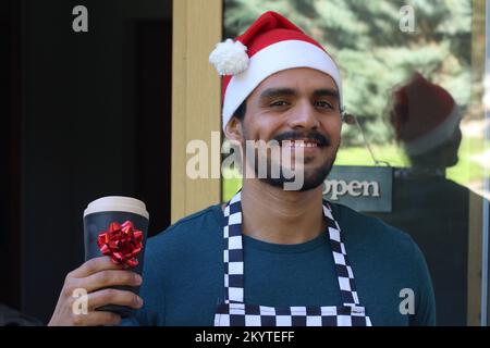 Joyous waiter doing a special promotion during christmas Stock Photo