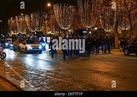 Paris, France, 01/12/2022. Moroccan and Tunisian supporters celebrate Morocco's qualification for the FIFA World Cup in Qatar, on the Champs Elysees, in Paris. Pierre Galan/Alamy Live News Stock Photo