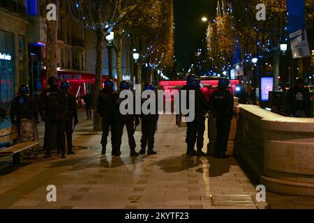 Paris, France, 01/12/2022. Moroccan and Tunisian supporters celebrate Morocco's qualification for the FIFA World Cup in Qatar, on the Champs Elysees, in Paris. Pierre Galan/Alamy Live News Stock Photo