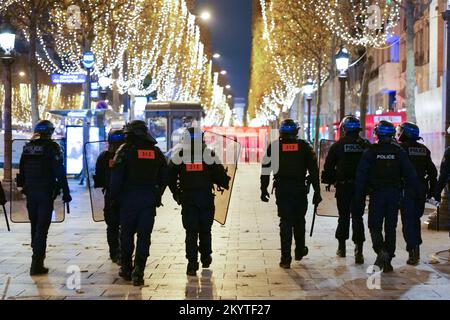 Paris, France, 01/12/2022. Moroccan and Tunisian supporters celebrate Morocco's qualification for the FIFA World Cup in Qatar, on the Champs Elysees, in Paris. Pierre Galan/Alamy Live News Stock Photo