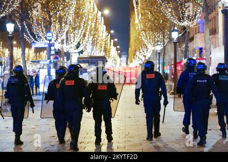 Paris, France, 01/12/2022. Moroccan and Tunisian supporters celebrate Morocco's qualification for the FIFA World Cup in Qatar, on the Champs Elysees, in Paris. Pierre Galan/Alamy Live News Stock Photo