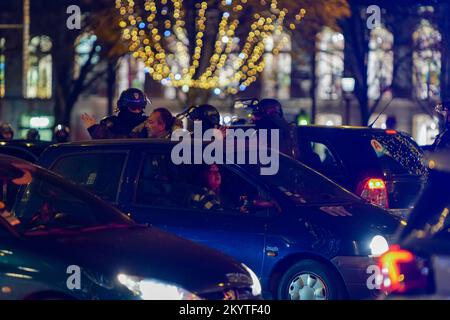 Paris, France, 01/12/2022. Moroccan and Tunisian supporters celebrate Morocco's qualification for the FIFA World Cup in Qatar, on the Champs Elysees, in Paris. Pierre Galan/Alamy Live News Stock Photo