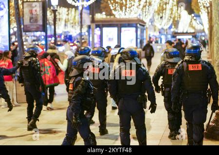 Paris, France, 01/12/2022. Moroccan and Tunisian supporters celebrate Morocco's qualification for the FIFA World Cup in Qatar, on the Champs Elysees, in Paris. Pierre Galan/Alamy Live News Stock Photo