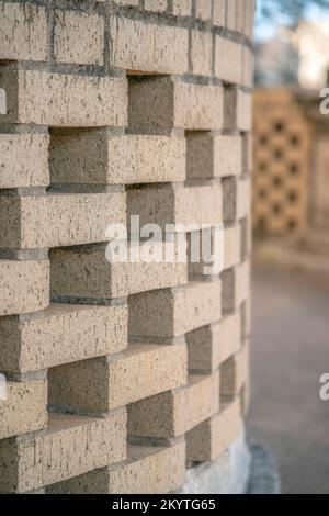 Austin, Texas- Selective focus curved wall structure with bricks. Close-up of a brick wall with curved alternating pattern design. Stock Photo