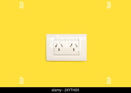 Double wall socket on a yellow background with copy space Stock Photo