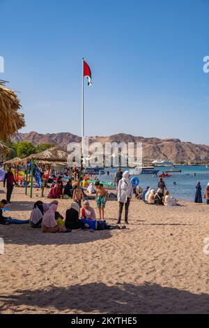 Al-Ghandour Beach in Aqaba Jordan looking South with the flag and flagpole commemorating the Arab Revolt Stock Photo