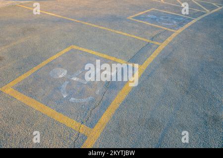 Camelback Mountain, Phoenix, Arizona- Parking lot sign for disabled on a concrete pavement. Parking slot for PWD's with painted yellow line and white Stock Photo
