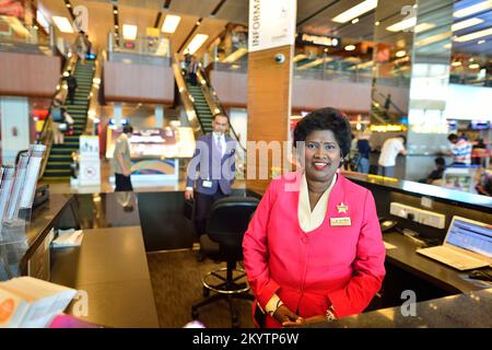 SINGAPORE - NOVEMBER 03, 2015: staff at Changi airport information desk. Singapore Changi Airport, is the primary civilian airport for Singapore, and Stock Photo