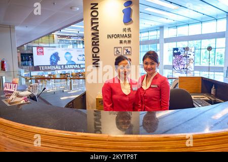 SINGAPORE - NOVEMBER 03, 2015: staff at Changi airport information desk. Singapore Changi Airport, is the primary civilian airport for Singapore, and Stock Photo