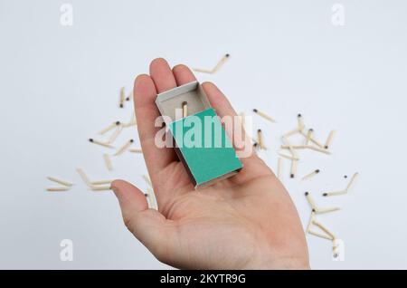 Last chance concept. The last match in the box against the background of broken matches Stock Photo
