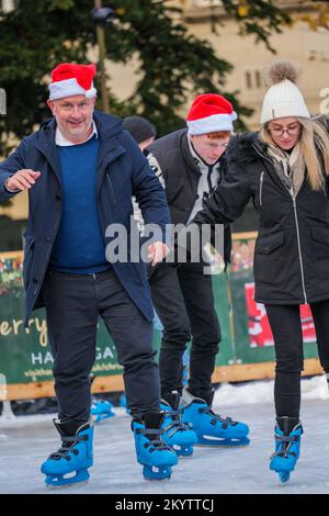Harrogate Ice Skating rink with ice skaters and people enjoying the winter event and Christmas attraction. Stock Photo